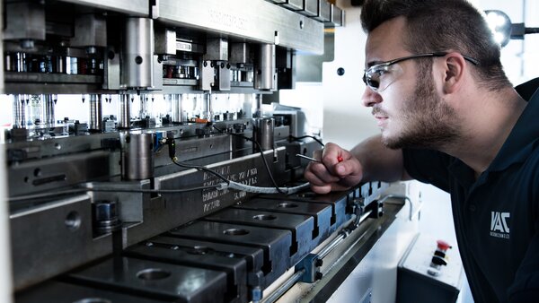 Employee Inspecting a Stampingpress